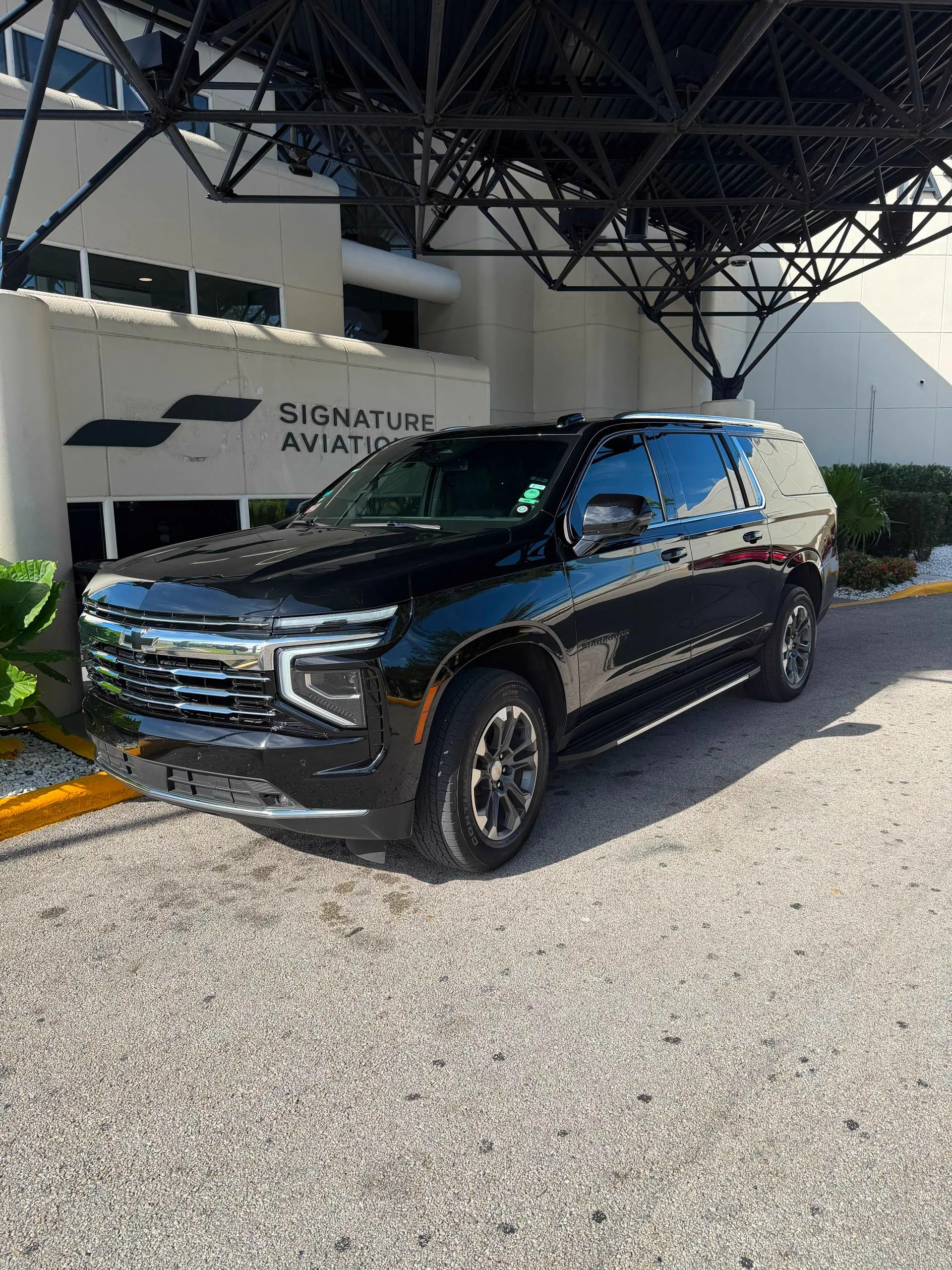 Black SUVs parked outside the Signature Aviation private terminal building (orlando to port tampa cruise transfer)