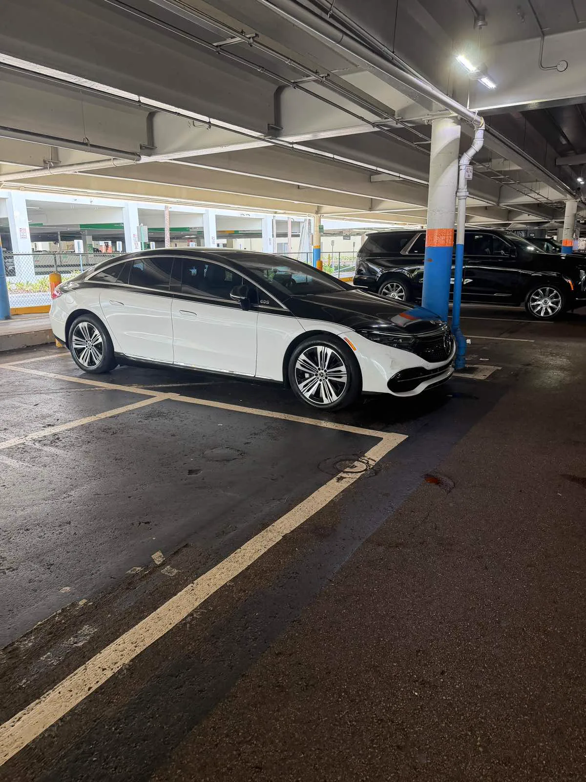 White Mercedes-Benz EQS luxury sedan with a black hood, front three-quarter view, Best Ride Miami chauffeur fleet