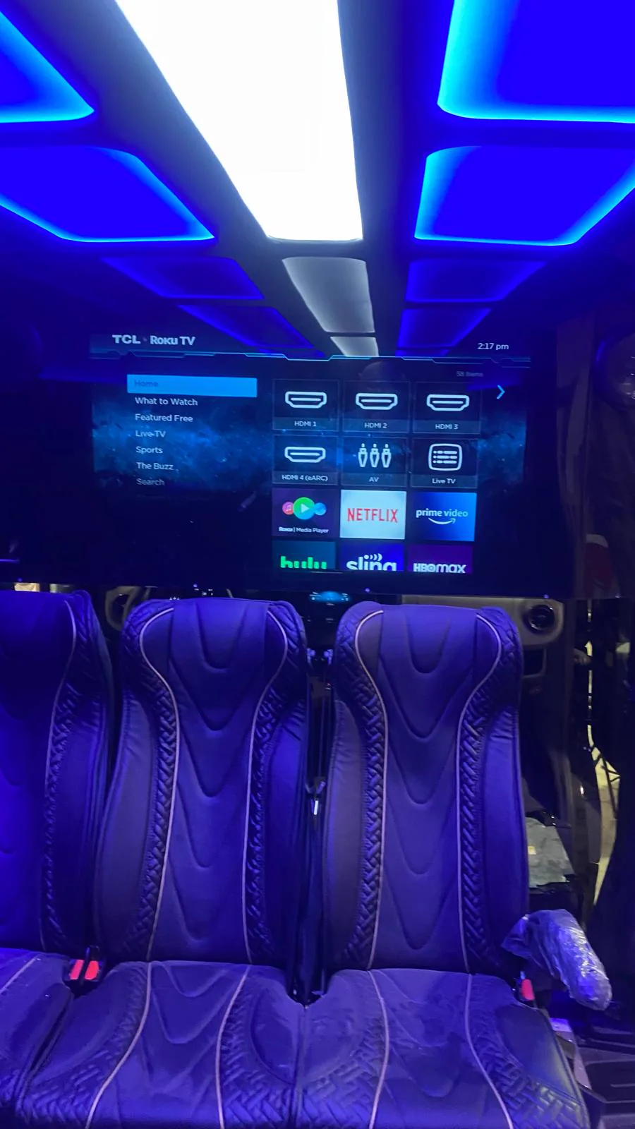 Flat screen and LED-lit ceiling inside the Best Ride party bus cabin